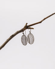 Load image into Gallery viewer, Celebrate your unique awesomeness and positive energy with this beautifully designed earrings in the shape of a Palm Leaf that across eons and cultures has symbolised victory with integrity. For that special touch all the pieces in our Jewellery Collection are delicately handcrafted in 925 Sterling Silver and finished with Rhodium Plating.