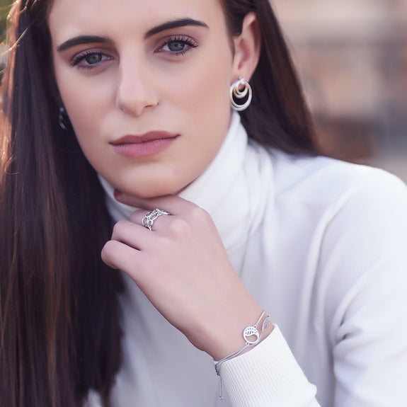Christina Jewelry & Watches 2019_2020 Lifestyle images highlighting Necklace Layering featuring Circles Of Joy Earrings, Cocktail Ring, Leaf Bracelet and Feather Bracelet.